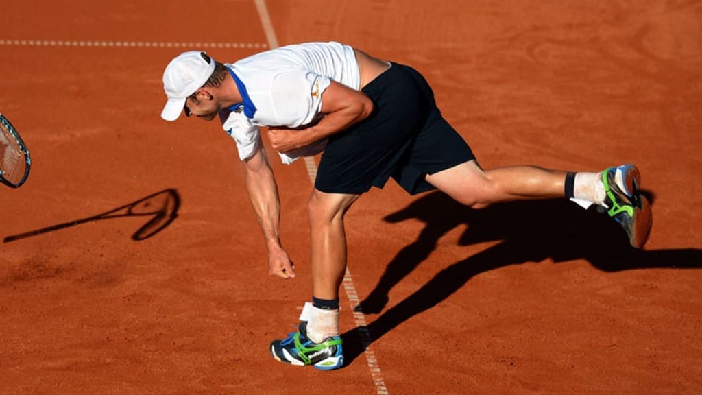 Tennis player breaking a racket