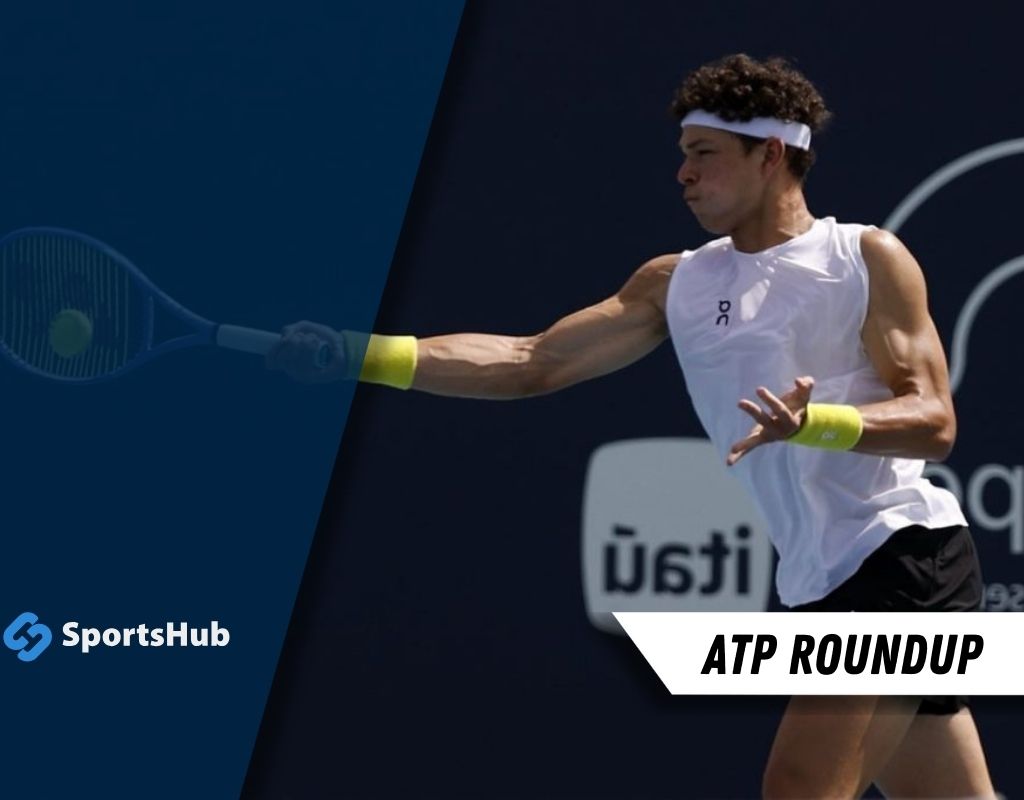 A tennis player in a sleeveless white shirt and yellow wristbands is in mid-swing, preparing to hit a ball on a court.