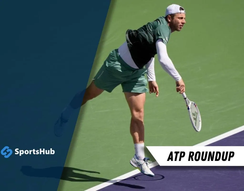 A tennis player serves on a green court, showcasing athletic form and concentration during an intense match.