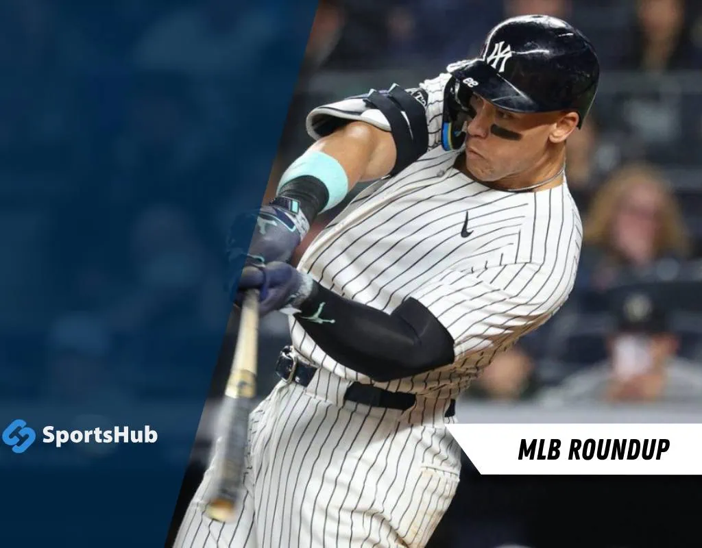 A baseball player in a striped jersey swings a bat in an MLB game, with a dark stadium and SportsHub logo in the corner.