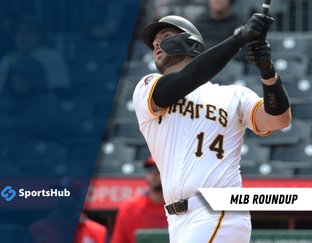 A Pittsburgh Pirates player swings a bat during a game, wearing a white jersey with yellow accents and the number 14.