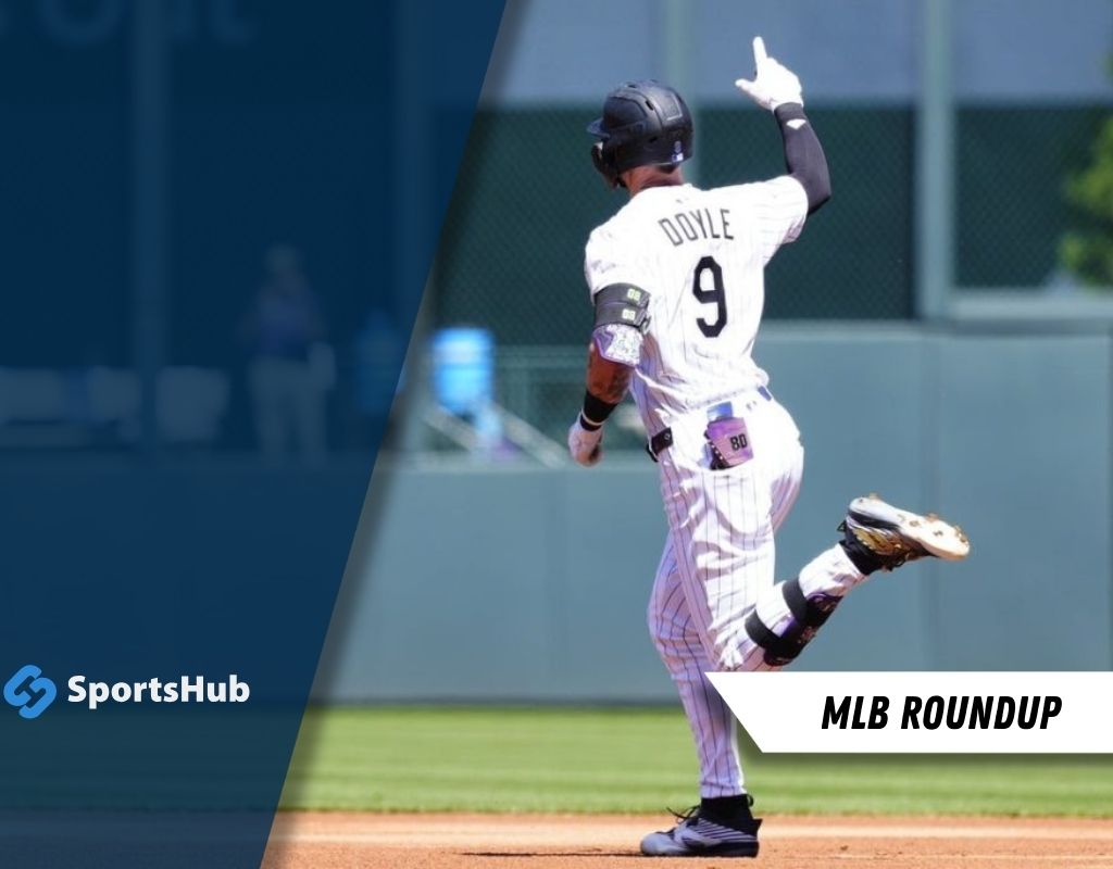 A baseball player wearing a striped jersey with "Doyle" on the back celebrates after hitting a play, raising his finger in triumph.