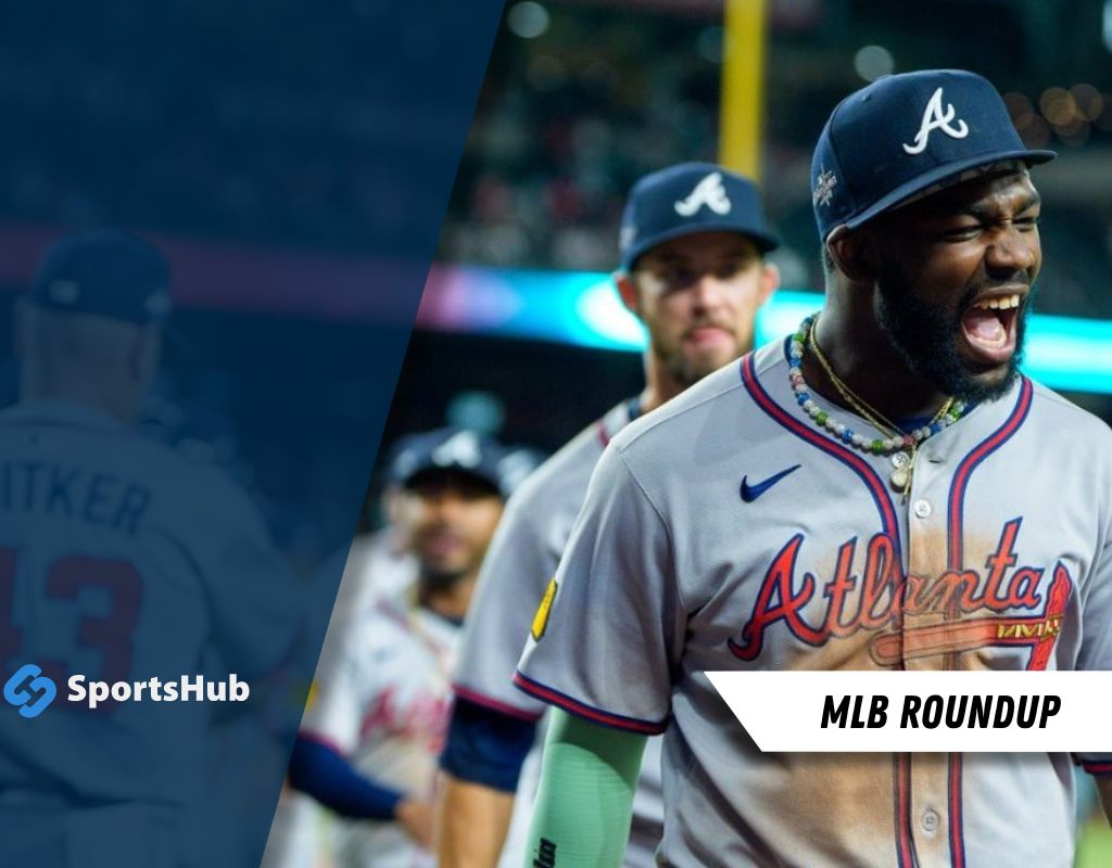 A group of Atlanta Braves players in gray uniforms walks off the field