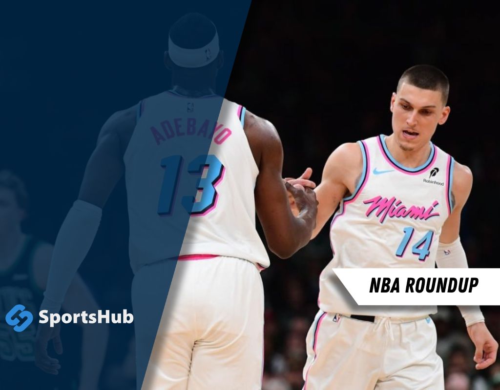Two Miami Heat players celebrate a play, wearing vibrant pink and white jerseys, with "Miami" emblazoned across the front.