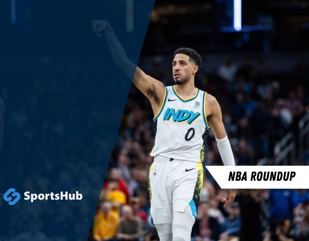 A basketball player celebrating on court, wearing an "INDY" jersey, with fans in the background and NBA Roundup text overlay.