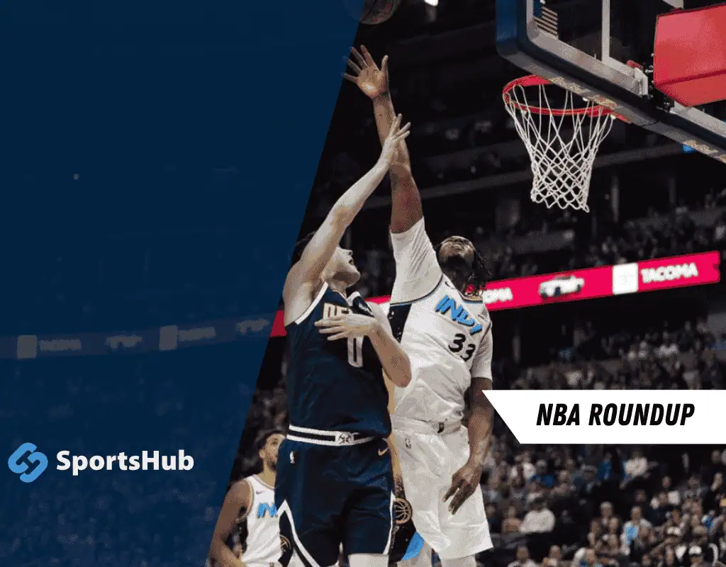 A basketball player attempts a dramatic shot while another player defends, showcasing an intense moment in an NBA game.