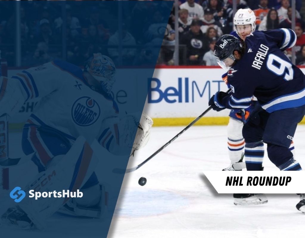 A hockey player in a blue and white uniform prepares to shoot the puck during an NHL game, with the opposing goalie visible.