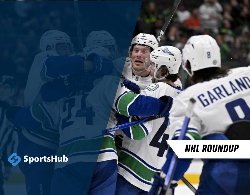 Hockey players in blue and green uniforms celebrate a goal, embracing on the ice with sticks raised, showcasing team camaraderie.