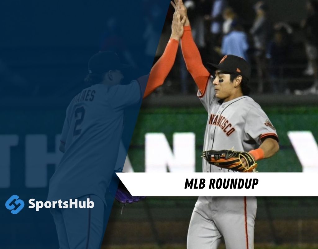Two baseball players in MLB uniforms high-fiving on the field