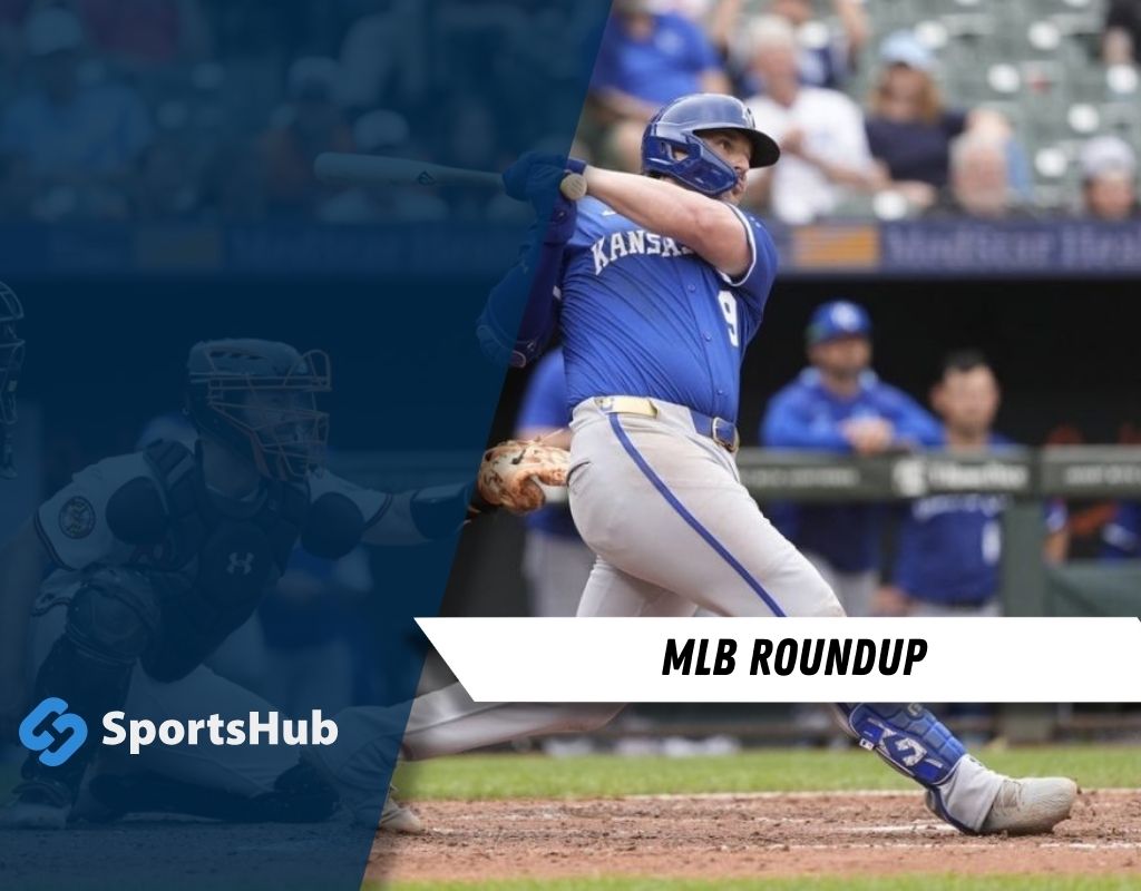 An MLB player swings a bat at home plate with a catcher in the foreground, capturing an intense moment of a baseball game.