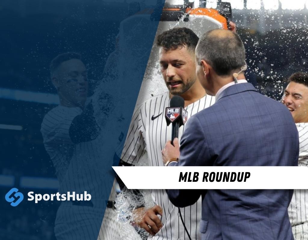 A sportscaster interviews a celebration-soaked baseball player in pinstripes