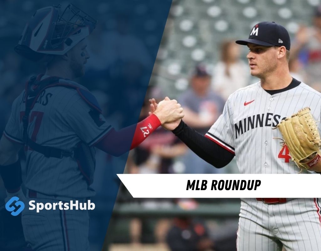 Two baseball players shake hands on the field, showcasing team spirit with a focus on their uniforms and the action of camaraderie.