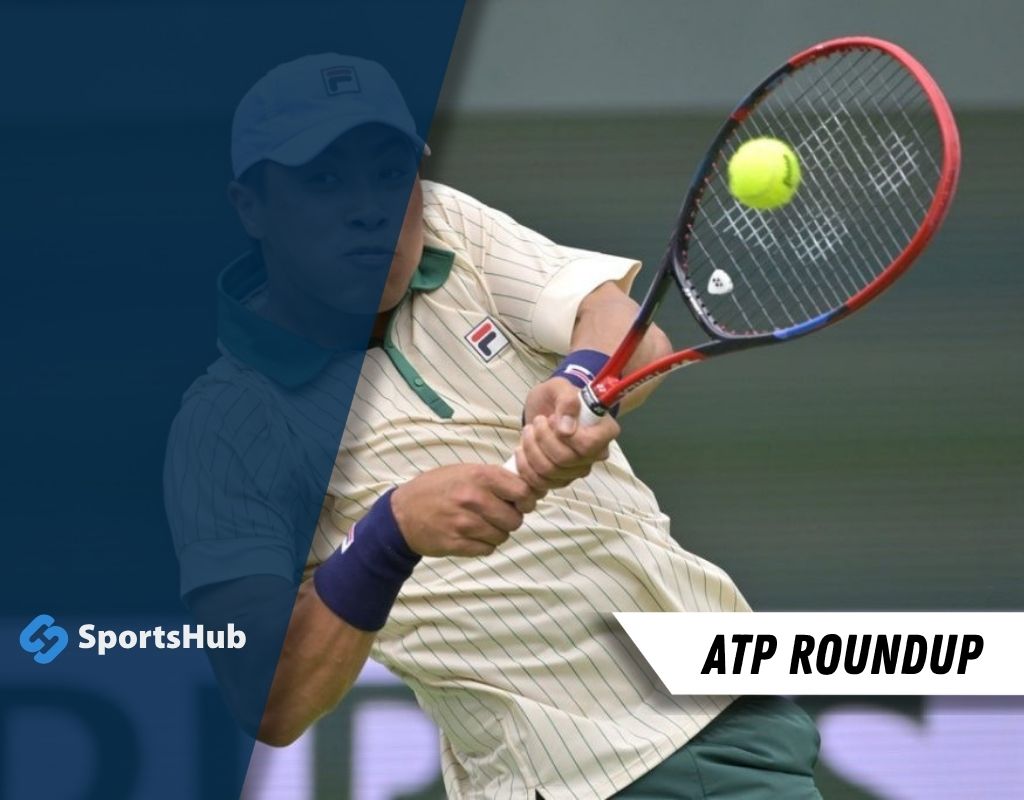 A tennis player in a cream-colored shirt strikes a ball with a racket, showcasing dynamic movement during a match.