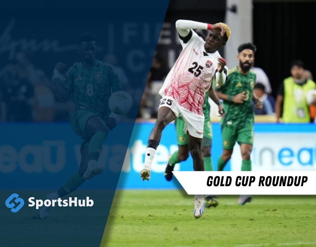 A player in a white jersey with red patterns kicks a soccer ball on the field