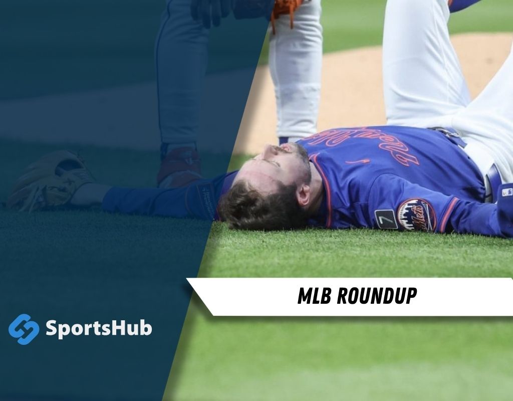 Baseball player in blue uniform lies on the field, eyes closed, with another player standing over him.