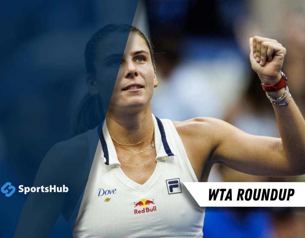 A tennis player celebrates a victory, wearing a white sports tank top with brand logos, raising her fist in excitement.