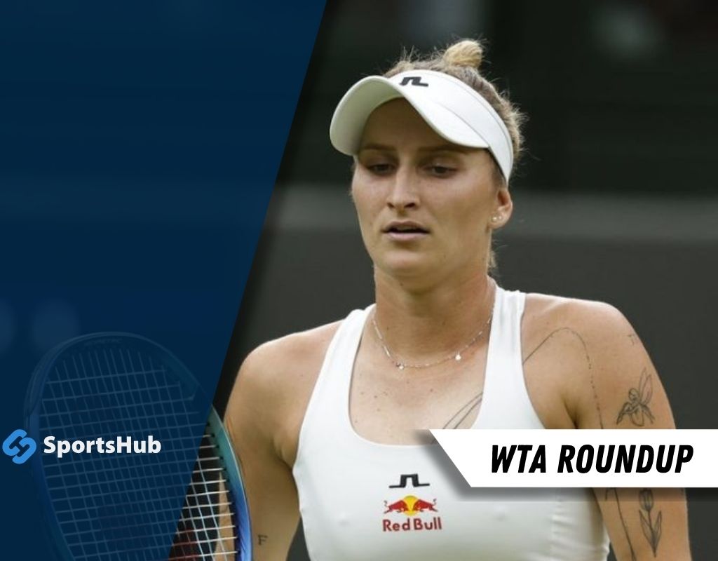 A female tennis player in a white tank top with Red Bull branding stands on the court, surrounded by a blue background