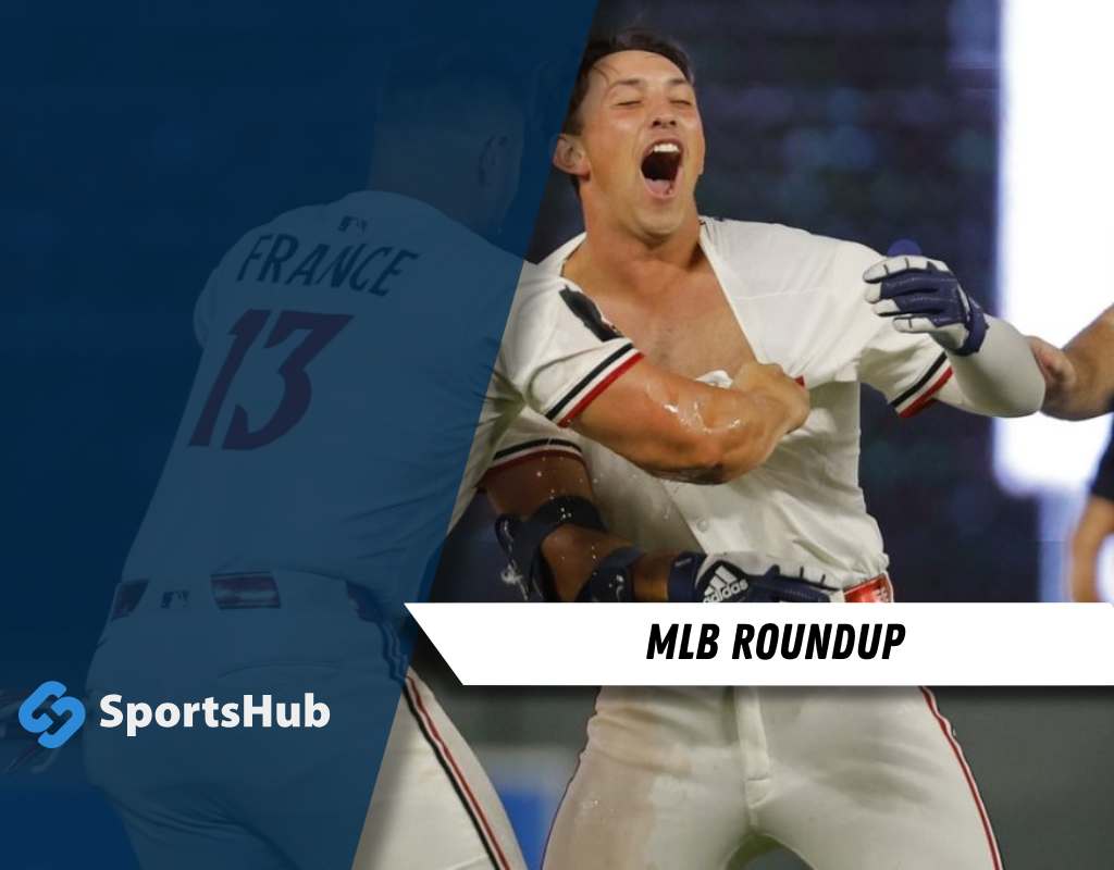 Two players engage in a passionate moment during an MLB game, showcasing teamwork and athleticism, with "MLB ROUNDUP" highlighted below.