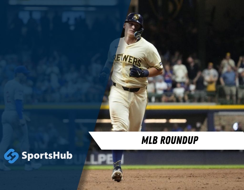 A player in a Brewers uniform runs towards home plate amidst a cheering