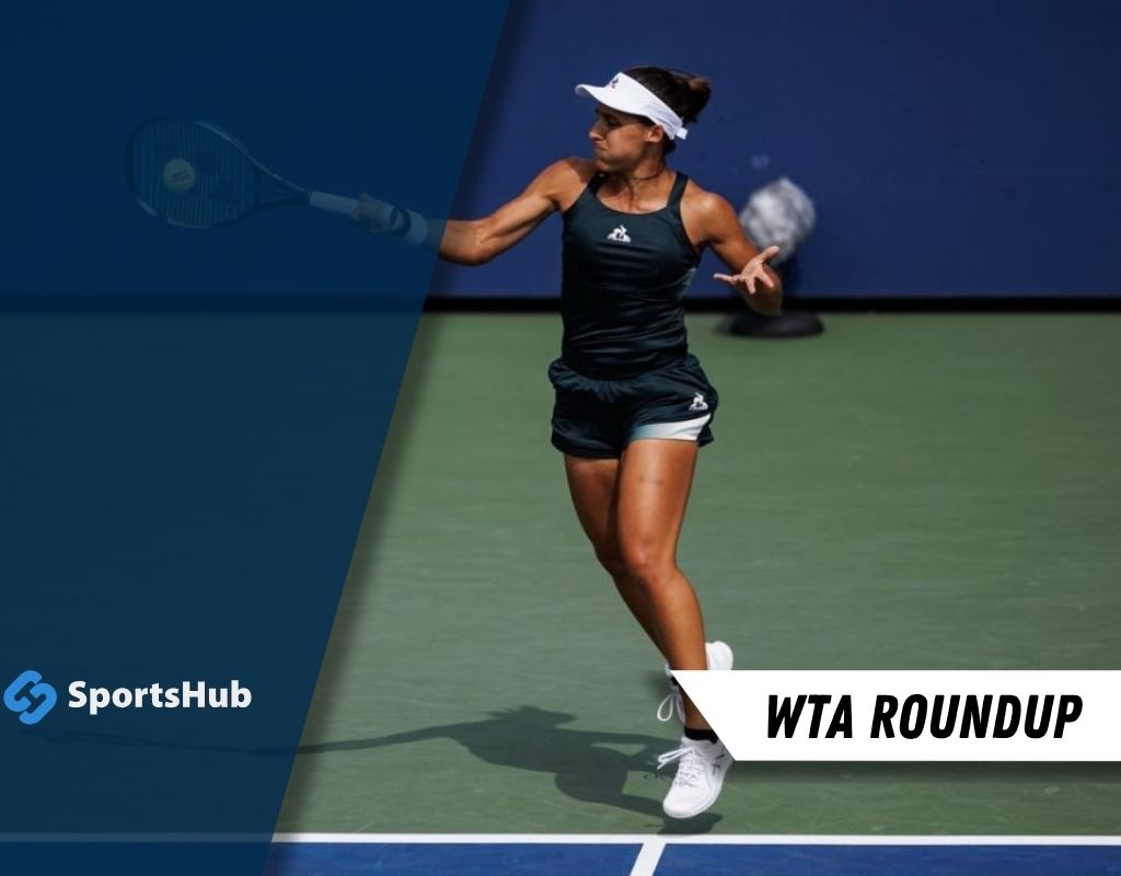 A woman is playing tennis on a court, showcasing her athletic skills in the sport.