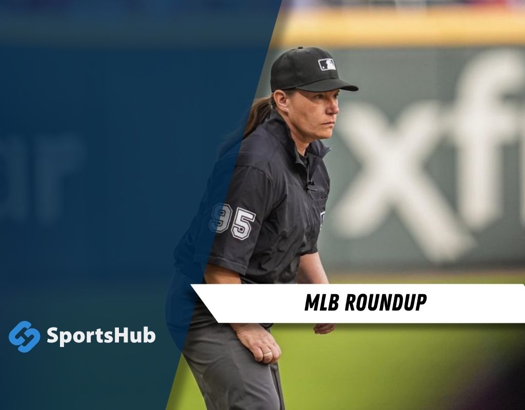 An MLB umpire in a black uniform, wearing a cap and shirt with the number 95, officiates a game on the field. SportsHub logo in the corner.